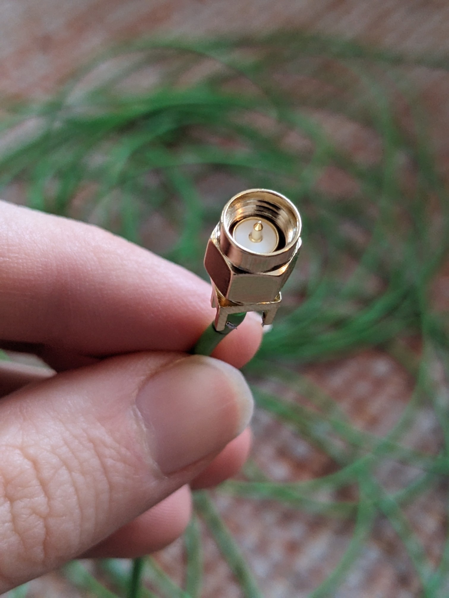 A golden screwable connector on the end of the wire.